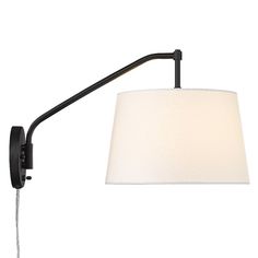 a black wall light with a white shade