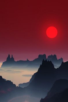 the sun is setting over mountains with fog in the foreground and red sky above