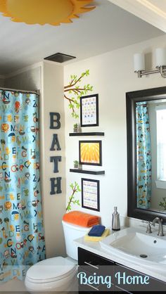 a bathroom with blue and yellow shower curtains