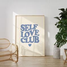 a poster with the words self love club on it next to a chair and potted plant