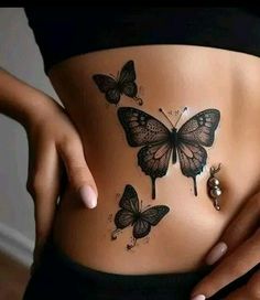 a woman's stomach with butterflies on it