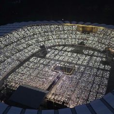 an aerial view of the stadium's roof at night, lit up with hundreds of lights