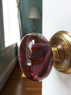 a close up of a door knob with a glass ball on it's side