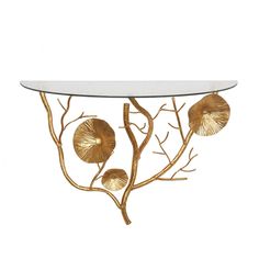 a glass table with gold leaves on it