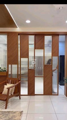 a living room filled with furniture and lots of glass doors on each side of the wall