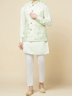 This Mint Green Kurta Bundi Jacket Set will instantly give an elegant look. This 3 piece kurta bundi set features a mint green mirror embroidered bundi jacket with a mint green kurta, front button placket, and a mandarin collar. It is paired with white churidar pants. An ideal outfit for traditional occasions, and special events.

Size Chart For Men





	
	
					Men's Size Chart
		

		
		
						
				Size Chart For Men
				Custom Size Measurement Guide
			
			
				
				
				Custom Size Measureme White Churidar, Green Mirror, Green Mirrors, Churidar, Mandarin Collar, Anarkali, Spring Break, Button Placket, Skirt Length