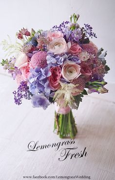 a bouquet of pink and purple flowers on a table