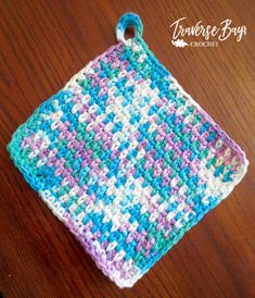 a crocheted dishcloth sitting on top of a wooden table