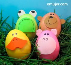 four stuffed animals sitting in the grass near eggs with faces painted on them and eyes drawn on