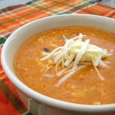 a bowl of soup with cheese on top