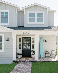 a house with a surfboard in front of it