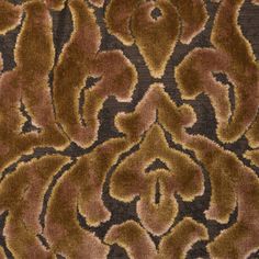 an animal print fabric with brown and tan colors on it's surface, showing the pattern