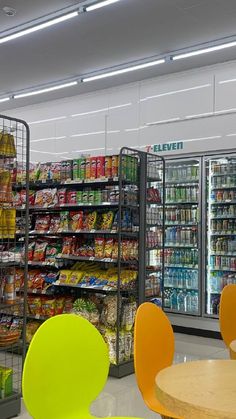 an empty grocery store filled with lots of food and drink bottles on the shelves next to chairs