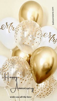 a bunch of white and gold balloons with the words happy anniversary written on one balloon