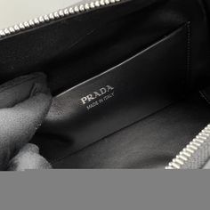 SHOP MORE LUXURY PRODUCTS HERE Description Prada Small Handbag Black For Women, Women’s Bags 10in/26cm 1BA366_2DDJ_F0002_V_OOO A study of the lines characterizes this medium handbag. It stands out for its absolutely elegant silhouette emphasized by the zipper closure with a sinuous effect. The enameled metal triangle logo decorates the accessory. Size: 25.5 x 18 x 13.5 cm /10 x 7.1 x 5.3 inches (Length x Width x Height) BlackHandlesDetachable, adjustable 105 cm shoulder strapMetal hardware High-end Black Pouch Satchel, Black Top Handle Bag With Zipper Pocket, Designer Black Top Handle Pouch, High-end Black Pouch Bag, Black Top Handle Pouch For Shopping, Luxury Black Shoulder Bag Pouch, Luxury Black Satchel Pouch, Luxury Black Top Handle Pouch, High-end Black Bag With Removable Pouch