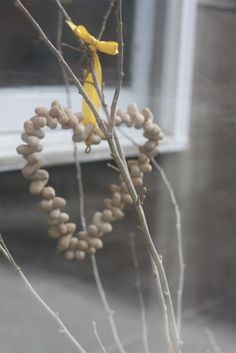 a bunch of fruit hanging from a tree next to a window with a yellow ribbon on it