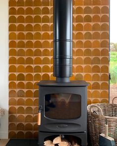 a wood stove sitting in front of a wall with circles on it's side