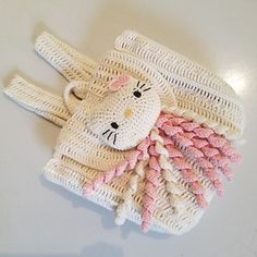 a white and pink brush with a teddy bear on it's head sitting on a table