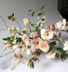 a bunch of flowers that are on top of a white tablecloth with the words hart floral above it