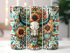 two cans with an animal skull and sunflowers painted on the sides, sitting on a table