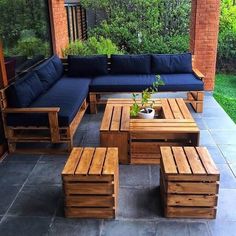 an outdoor patio with wooden furniture and plants