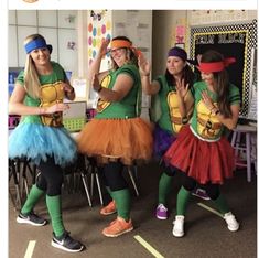 four girls dressed in teenage mutant costumes and tutus, one girl is waving at the camera