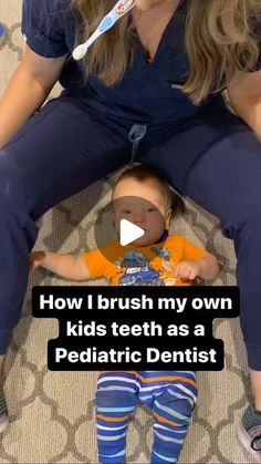 a woman sitting on the floor with a baby in her lap and toothbrush over her mouth