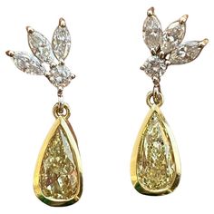 Specifications: main stone:0.69CTW NATURAL PEAR SHAPE DIAMONDS  additional:0.31CTW 22PS ROUND DIAMONDS G SI1-2  diamonds:24PCS carat total weight:1.01 ctw metal:14K GOLD TYPE: earrings weight:2.9 gr HOOP DIAMETER:0.5 INCH Pear Shapes, Yellow Diamonds, Fancy Yellow Diamond, Pear Shaped Diamond, Modern Earrings, Yellow Diamond, White Diamonds, Pear Shape, Modern Jewelry