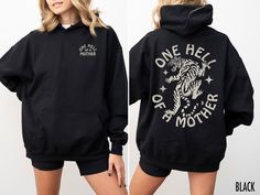 Roar with retro style in this "One Hell of a Mother" hooded sweatshirt featuring a fierce vintage tiger graphic. Perfect for moms who tackle parenthood like a wild adventure and still manage to keep their stripes in style. Production Time: 1-5 days Shipping Time: 2-5 days Description: Gildan 18500 Unisex Hooded Sweatshirt Medium-heavy fabric Loose fit Runs true to size 50% cotton, 50% polyester Sewn-in label Care Instructions: Machine wash: cold or warm (max 40C or 105F) Tumble dry: low heat Do Casual Cotton Hoodie With Front And Back Print, Cotton Sweatshirt With Front And Back Print For Winter, Winter Cotton Sweatshirt With Front And Back Print, Casual Hoodie With Front And Back Print For Winter, Cotton Hoodie With Front And Back Print, Casual Long Sleeve Hoodie With Front And Back Print, Casual Winter Sweatshirt With Front Print, Cotton Sweatshirt With Front And Back Print, Retro Relaxed Fit Hoodie For Fall