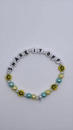 a bracelet with smiley face beads and words that spell out the word share it off