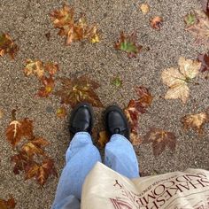 a person standing in front of leaves on the ground