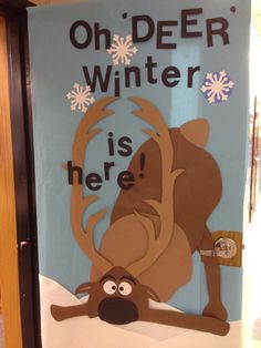 a door decorated to look like a winter scene with a reindeer and snowflakes