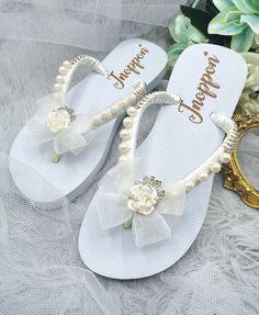 Description The beautiful rhinestone and customizable Flip Flops for the beach brides, bridesmaids, vacation, honeymoon or any occasion you desire to look gorgeous. Perfect in any outfit! Being unique and stunning on design, these flip flops must be your must-have item! The sandal is anti-slip, comfortable and durable as it is made from high quality rubber from the South of Thailand, where is famous for the best rubber tree. Moreover, the crystals are decorated on the sandal with effective adhes Elegant Summer Bridal Accessories For Bridal Shower, Pearl White Summer Wedding Shoes, Adjustable Bridal Accessories For Summer Parties, Summer Bridal Accessories For Bridal Shower, Summer White Bridal Accessories For Bridal Shower, White Summer Bridal Accessories For Bridal Shower, White Bridal Accessories For Summer Bridal Shower, Elegant White Wedding Shoes For Beach Ceremony, White Open Toe Flip Flops For Wedding