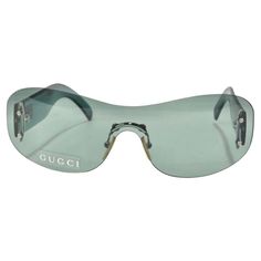 Get your hands on these incredible Gucci dead stock sunglasses circa 1990s! The perfect Y2K shield style sunglasses in this gorgeous teal/light green color. These are such a classic and fun statement pair of sunglasses! Match these to your favorite Gucci handbag and pair with some Louis Vuitton boots for a chic vintage look. Never been worn, new dead stock sunglasses in perfect condition, please see photos. Made in Italy. Luxury Blue Gucci Sunglasses, Gucci Sunglasses Star, Vintage Luxury Silver Sunglasses, High Fashion Sunglasses, Gucci Sunglasses Green, 2024 Icon, Statement Glasses, Outfit Generator, Fire Clothes