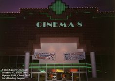 the front entrance to a movie theater at night