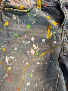 These splatter jean shorts will quickly become your favorite this to wear this summer.  Yellow, orange and white paint five these shorts a fun, springy feel. Pair them up with your favorite tee and some flip flops and you're readyfor anything. These are handmade items, so color variations may differ slightly.  #jeanshorts #bermudashorts #splatterjeans #shortsandflipflops #summerfun #summervibes #shopsmall #tiedye #bleachdye #vintagefeel  DETAILS Size: 12 with some stretch Color: faded denim  Det Spring Denim Bottoms With Paint Splatter, Spring Paint Splatter Denim Bottoms, Multicolor Paint Splatter Bottoms For Spring, Spring Multicolor Paint Splatter Bottoms, Casual Paint Splatter Bottoms For Summer, Bermuda Jean Shorts, Tie Dye Jeans, Jaune Orange, Summer Yellow