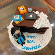 a birthday cake for a workaholic with an image of a man sitting on his desk