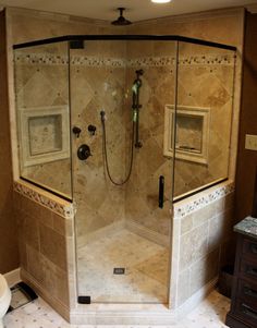 a walk in shower sitting inside of a bathroom