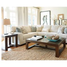 a living room with couches, tables and pictures hanging on the wall above them