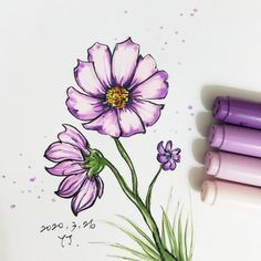 two markers are next to a drawing of a flower