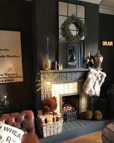 a living room filled with furniture and a fire place in front of a mirror on the wall