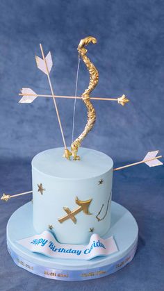 a birthday cake with an arrow on top