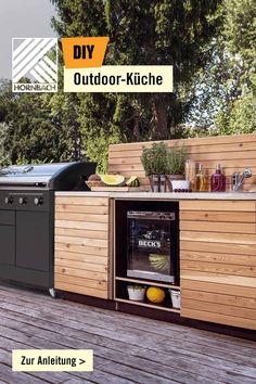 an outdoor kitchen is built into the deck