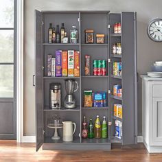 a kitchen pantry with various items in it and a clock on the wall behind it