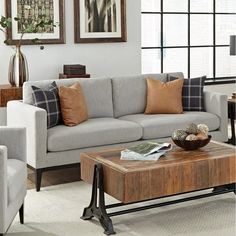 a living room with two couches, a coffee table and pictures on the wall