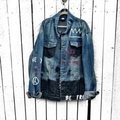 DESCRIPTION EACH PIECE IS MADE TO ORDER, HAND PAINTED BY GLORIA AND HER TEAM IN THEIR NYC STUDIO PRODUCT STEPS Medium blue denim wash. Graffiti style jacket with symbols and wording throughout, in black, white and red. Signed @wrenandglory. Due to each piece being hand painted, each jacket might have slight differences. Please allow 1-2 weeks delivery, as each jacket is hand painted, and made to order. Limited edition. FIT Slim fit. Stretch, comfortable denim. We recommend staying true to your n Streetwear Dark Wash Recycled Denim Jacket, Dark Wash Recycled Denim Jacket For Streetwear, Blue Recycled Denim Jacket For Streetwear, Urban Style Recycled Denim Streetwear Jacket, Urban Recycled Denim Jacket For Streetwear, Washed Recycled Denim Jacket For Streetwear, Washed Denim Jacket In Recycled Material For Streetwear, Painted Clothes Diy, Nyc Studio