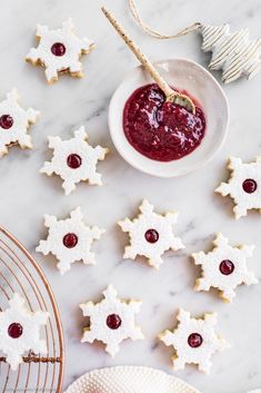 some cookies and jam on a white marble table with gold wire rack, ornament