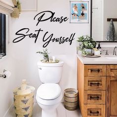 a white toilet sitting in a bathroom next to a sink