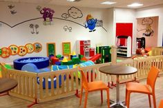 children's playroom with wooden tables and chairs