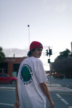 Male walking through the city wearing a white Why Clothing t-shirt and red beanie Clothing Product Photoshoot, Graphic Tee Photoshoot, Photoshoot Clothing Ideas, Street Editorial Photography, Clothing Photoshoot Ideas, Skater Photoshoot, Photoshoot Location Ideas, Clothing Shoot